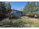 Exterior view of home with a spacious backyard, deck, and mature landscaping at 16933 E Bethany Pl, Aurora, CO 80013
