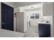Bright kitchen featuring white cabinets and counters paired with dark blue base cabinets at 16933 E Bethany Pl, Aurora, CO 80013