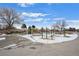 Community playground with swings, slides, and climbing structures, surrounded by mature trees at 16933 E Bethany Pl, Aurora, CO 80013