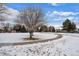 A snow-covered walking path meanders through a peaceful, open green space, perfect for a stroll at 16933 E Bethany Pl, Aurora, CO 80013