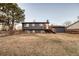 Expansive backyard featuring a spacious lawn, mature tree, and a deck with access to the home at 18200 E Asbury Pl, Aurora, CO 80013