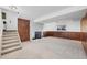 Spacious basement area with wood paneling and stairs to the upper level at 18200 E Asbury Pl, Aurora, CO 80013