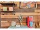 Close up of decor on wood paneled wall including shelf, plants, and coffee maker at 18200 E Asbury Pl, Aurora, CO 80013