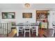 Bright dining area with a wooden accent wall, decor, and a view of the living area at 18200 E Asbury Pl, Aurora, CO 80013