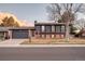 Charming two-story home with brick accents, complemented by a well-manicured front yard and mature tree at 18200 E Asbury Pl, Aurora, CO 80013