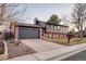 Lovely home featuring a brick-and-siding exterior, attached garage, and driveway at 18200 E Asbury Pl, Aurora, CO 80013