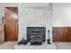 Detailed view of the stone fireplace with wood-burning stove at 18200 E Asbury Pl, Aurora, CO 80013