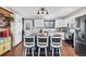 Modern kitchen with white cabinetry, stainless steel appliances, and breakfast bar seating at 18200 E Asbury Pl, Aurora, CO 80013
