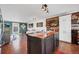 Kitchen island with wood countertop and wood paneled wall in open concept layout at 18200 E Asbury Pl, Aurora, CO 80013
