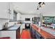Bright kitchen with stainless appliances, white cabinets, island with wood countertop, and subway tile backsplash at 18200 E Asbury Pl, Aurora, CO 80013