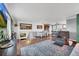 Open-concept living area with hardwood floors, view of dining and kitchen at 18200 E Asbury Pl, Aurora, CO 80013