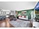 Open-concept living room connects to the kitchen, featuring hardwood floors and green walls at 18200 E Asbury Pl, Aurora, CO 80013