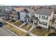 Aerial view of a neighborhood street with charming homes, manicured lawns, and tree-lined sidewalks at 4540 Crestone Peak St, Brighton, CO 80601