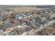 Aerial view of a suburban neighborhood featuring colorful homes and well-maintained yards at 4540 Crestone Peak St, Brighton, CO 80601