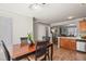 Open-concept dining area seamlessly connects to the kitchen, creating a warm and social atmosphere in the home at 4540 Crestone Peak St, Brighton, CO 80601