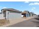 Row of garages showcasing varying exterior colors and designs, adding character to the street at 4540 Crestone Peak St, Brighton, CO 80601