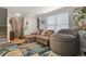 Inviting living room featuring a large couch, beanbag chair, modern rug, and ample natural light at 4540 Crestone Peak St, Brighton, CO 80601