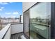 Outdoor balcony featuring a view of neighborhood buildings with a sliding glass door to a bright living area at 1258 Yates St, Denver, CO 80204