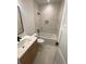 Chic bathroom with a tub, toilet, and vanity with modern sink and fixtures at 1258 Yates St, Denver, CO 80204