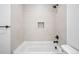 Modern bathroom with tiled walls, tub, and sleek fixtures at 1258 Yates St, Denver, CO 80204