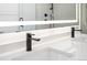Modern bathroom featuring double sinks, quartz countertops, and a large, lighted mirror at 1258 Yates St, Denver, CO 80204
