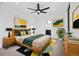 Cozy bedroom with a ceiling fan, modern decor, and a view into the attached bath at 1258 Yates St, Denver, CO 80204