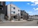 Modern exterior view of a townhome with white facade, black windows, and clean architectural lines at 1258 Yates St, Denver, CO 80204