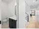 Hallway featuring a half bath and staircase with views of the modern design elements of the home at 1258 Yates St, Denver, CO 80204