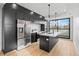 Contemporary kitchen with stainless steel appliances, modern dark cabinets and hardwood floors at 1258 Yates St, Denver, CO 80204