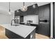 Modern kitchen with stainless steel appliances, sleek cabinets, quartz countertops, and stylish pendant lights at 1258 Yates St, Denver, CO 80204