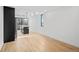 Bright, modern living room with hardwood floors, neutral walls, and a glimpse of a contemporary kitchen at 1258 Yates St, Denver, CO 80204