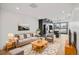 Inviting living room features neutral decor, plush seating, hardwood floors, and an open layout to kitchen at 1258 Yates St, Denver, CO 80204