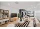 Open-concept living room features bright, natural light, modern furnishings, hardwood flooring, and adjacent kitchen at 1258 Yates St, Denver, CO 80204