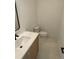 Stylish powder room with modern vanity, white countertop, and sleek fixtures at 1258 Yates St, Denver, CO 80204