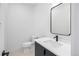 Stylish powder room featuring a modern vanity with sleek fixtures and a minimalist design at 1258 Yates St, Denver, CO 80204