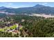Scenic aerial view of a property nestled among lush greenery and mountains at 20425 Flint Ln, Morrison, CO 80465