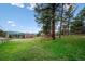 Spacious green lawn surrounded by mature trees and a split rail fence at 20425 Flint Ln, Morrison, CO 80465