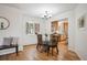 Bright dining area featuring wood floors, large windows, and adjacent kitchen for easy serving at 20425 Flint Ln, Morrison, CO 80465