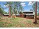 Exterior view of a spacious home with a greenhouse and well-maintained lawn at 20425 Flint Ln, Morrison, CO 80465