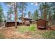 Large home exterior featuring a greenhouse and an outbuilding on a well-manicured lawn at 20425 Flint Ln, Morrison, CO 80465