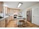 Bright kitchen with light wood cabinets, stainless steel appliances, and island with breakfast bar seating at 20425 Flint Ln, Morrison, CO 80465