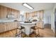 Bright kitchen with light wood cabinets, stainless steel appliances, and island with breakfast bar seating at 20425 Flint Ln, Morrison, CO 80465
