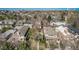 Neighborhood aerial view showcases a community setting with lush trees, blue sky, and residential homes at 451 Harrison St, Denver, CO 80206