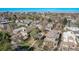 Aerial view of the property showcasing its location in a residential neighborhood with mature trees and city skyline view at 451 Harrison St, Denver, CO 80206
