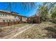 Large backyard featuring driveway, adjacent to home and wooden privacy fence at 451 Harrison St, Denver, CO 80206