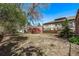 Spacious backyard featuring mature trees, an old shed, and a wooden fence at 451 Harrison St, Denver, CO 80206