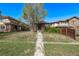 Charming brick home with a cozy front porch and mature trees in a well-established neighborhood at 451 Harrison St, Denver, CO 80206