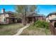 Charming brick home with a cozy front porch and mature trees in a well-established neighborhood at 451 Harrison St, Denver, CO 80206