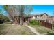 A cozy brick home with a quaint porch and mature landscaping at 451 Harrison St, Denver, CO 80206