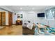 Cozy finished basement area with polished concrete floors, sliding door, and comfortable seating at 8256 E 28Th Dr, Denver, CO 80238